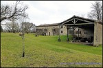 A vendre par TAIC Immobilier à Castres Grande longère de 1000m2 sur 8900m2 de terrain comprenant partie privative, 7 studios et dépendances,puit,lavoir.